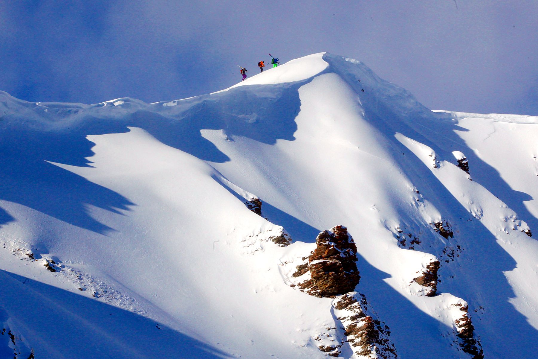 Ski tourers hiking a ridge in the Val d'Anniviers