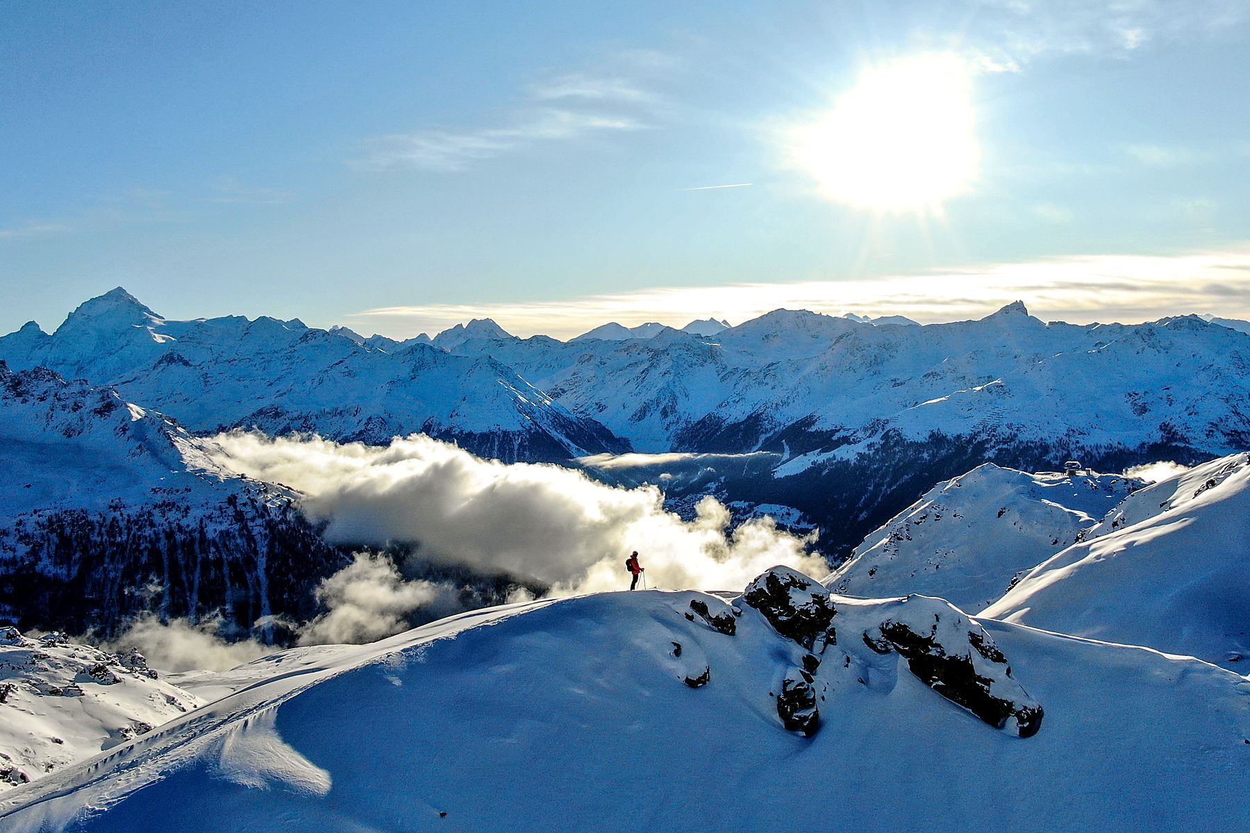 Ski touring on a Valais ridge above the clouds