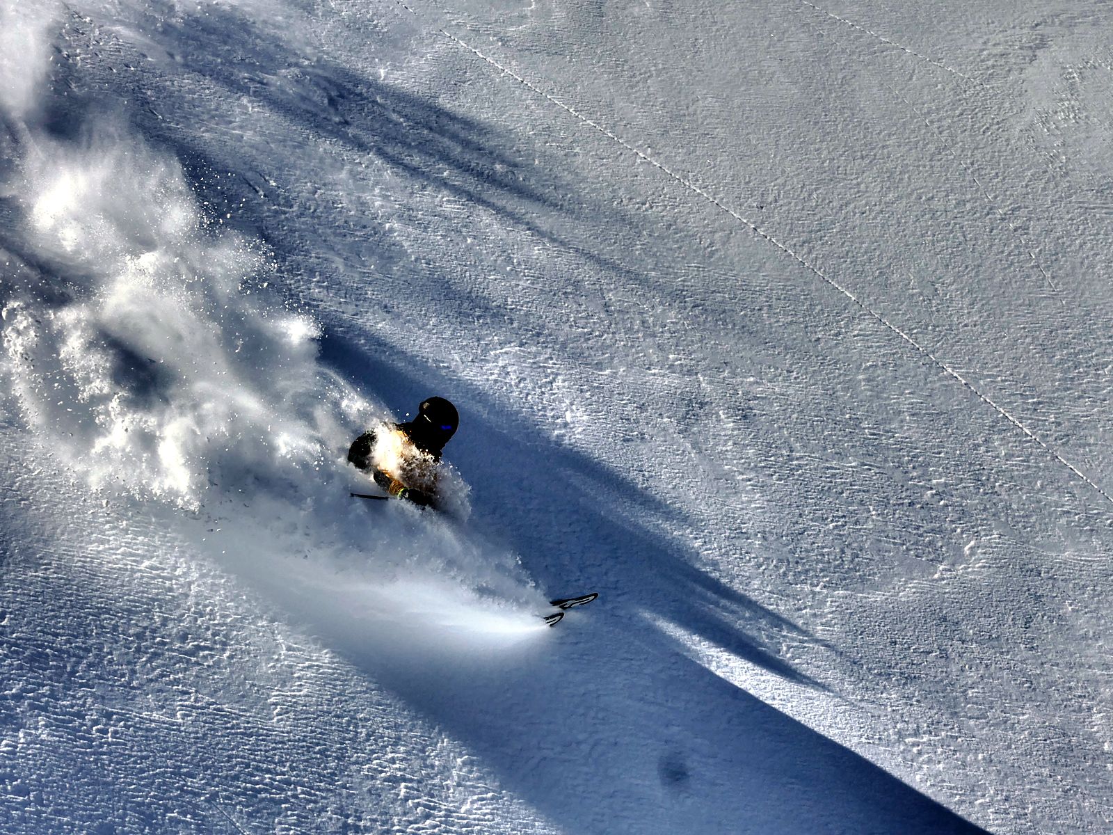 Steep powder run seen from above in the Valais