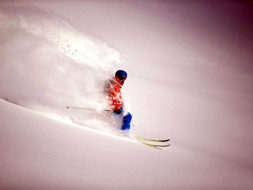 Powder turn with snow spray on a Le Beau Ski trip